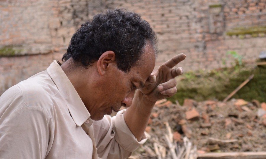 Lakshman Shrestha clears the rubble of his house following the Nepal earthquake.