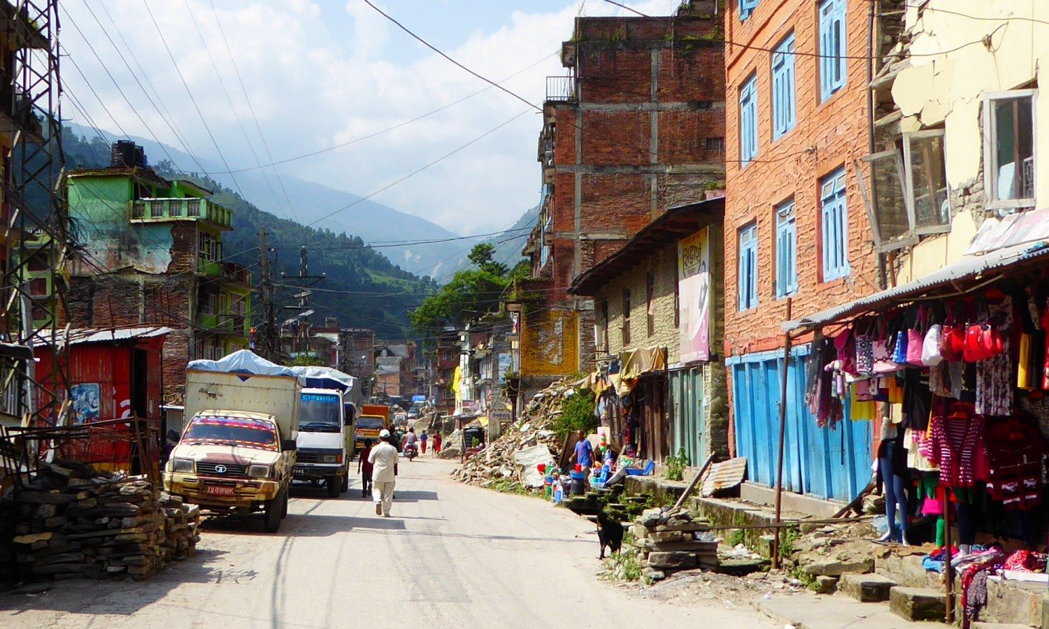 The main road in Bahrabise, Sindhupalchowk, four months after the earthquake. Piles of rubble and building materials line the road.