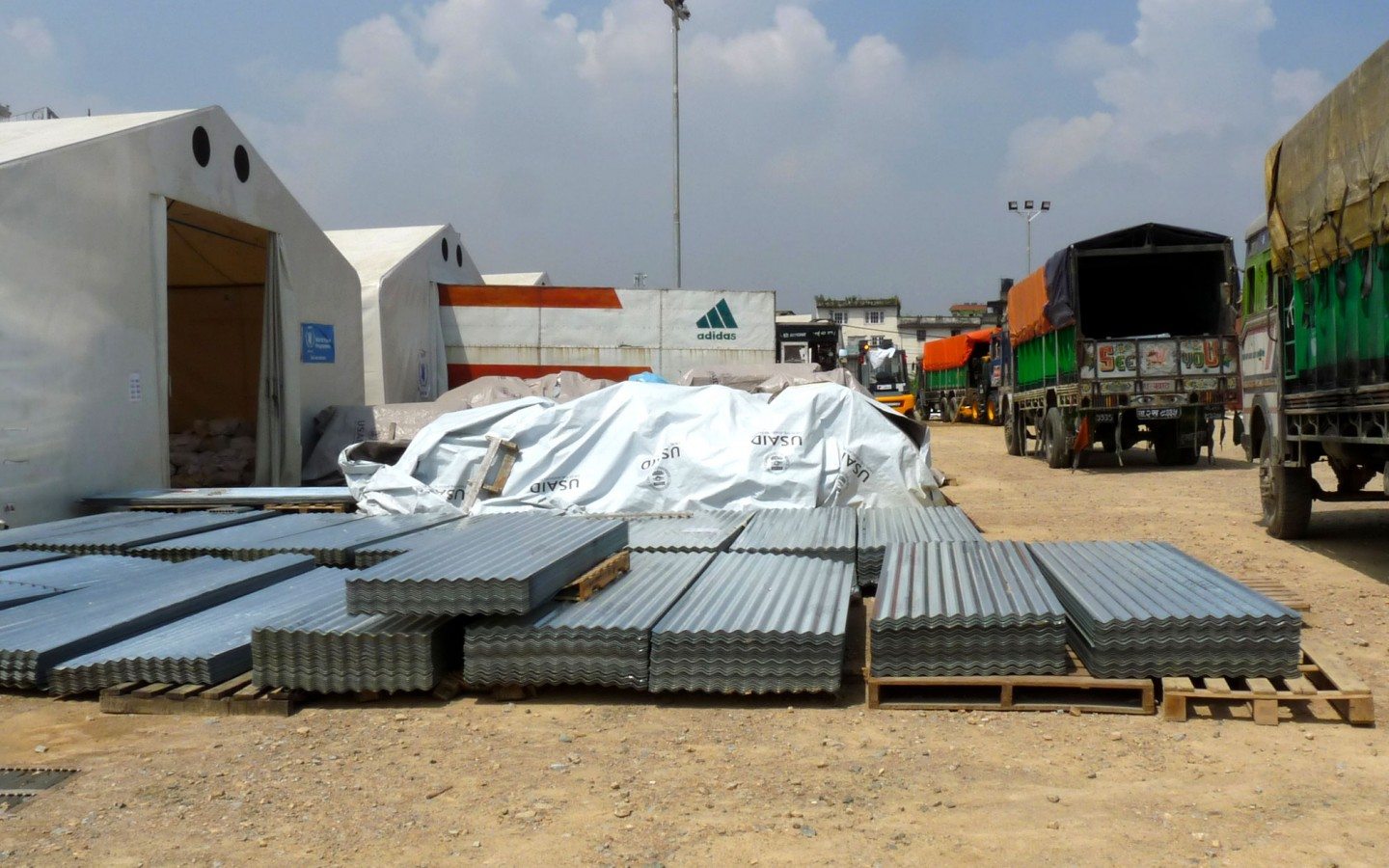 Zinc roofing materials for homes and shelters awaits distribution at the WFP base in Kathmandu. 