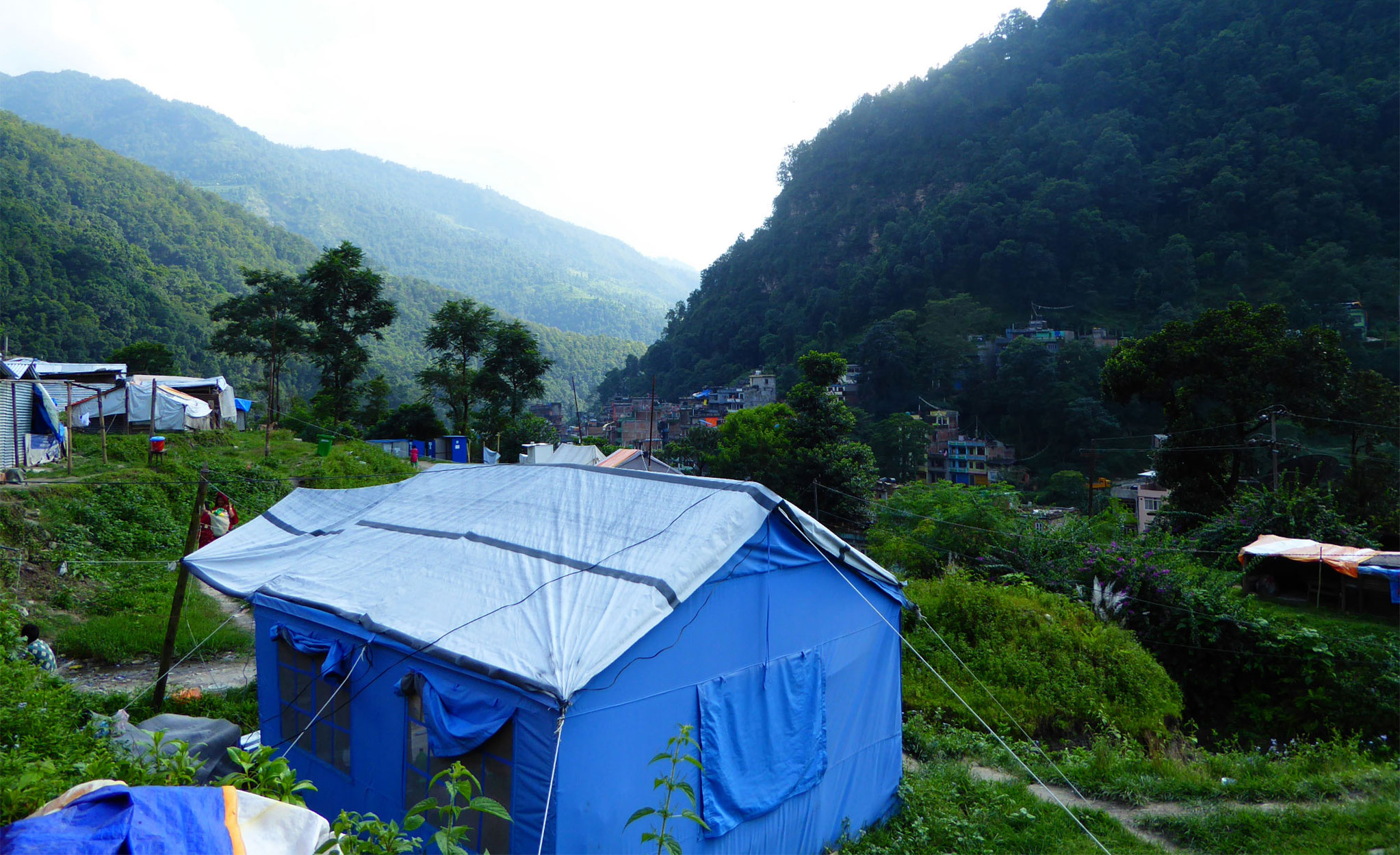 In Sindhupalchok, the district worst affected by the earthquake, thousands still live in temporary shelters. This is one such camp in Bahrabise, close to the Chinese border. Photo: Patrick Ward