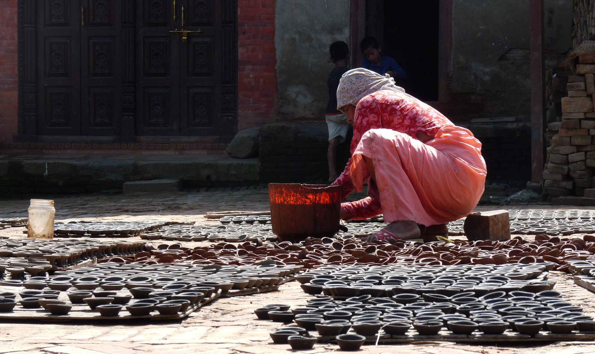 Bhaktapur is famous for its traditional pottery industry, and is home to two “pottery squares” where rows of clay pots can be seen drying in the sun. The potters are particularly busy during the Tihar festival of lights - one of the biggest festivals in Nepal - making diyekos (earthen lamps) which are then filled with oil and lit outside each household. In Hinduism, fire is an important symbol of cleansing and purification and its light dispels gloom and darkness. 