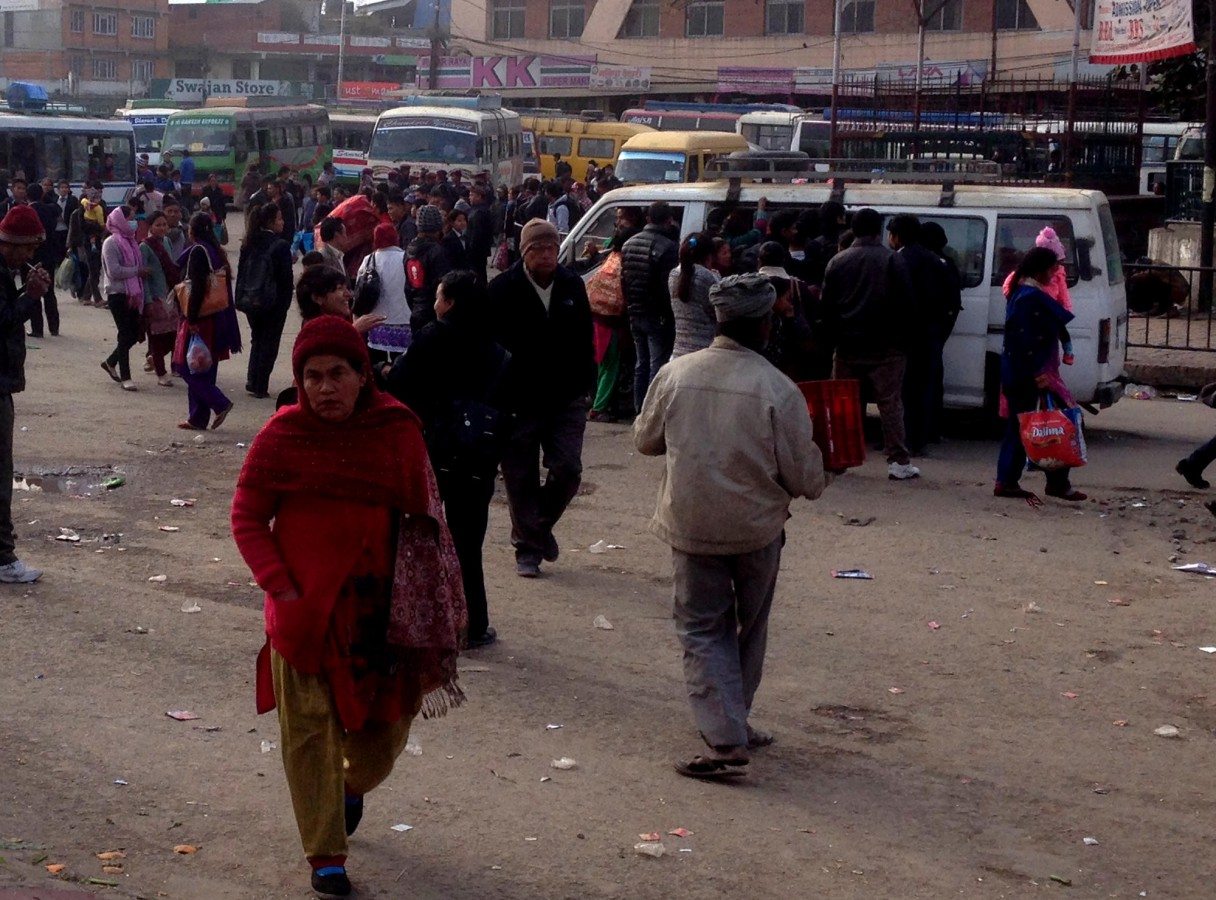 Dozens of people gather at Lagankhel bus station, listening as conductors call out their buses’ destinations. You have to be quick if you want a seat, or standing room, or something to hang on to. Photo: Patrick Ward