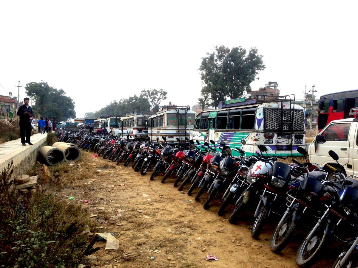 Here’s part of the problem. A kilometre-long line of buses waits for fuel at a petrol station. Stocks are only occasionally replenished, and it is common for drivers to wait several days to refuel. Some sit in their buses playing cards, some just go home and wait. Photo: Patrick Ward